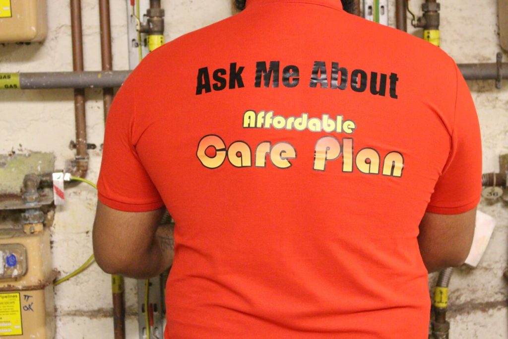 image-of-a-man-showing-affordable-flames-T-shirt-providing-plumbing-and-heating-services-home